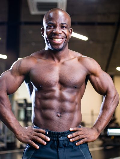 active african american handsome male training muscles arm workout gym .